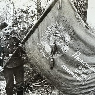 Original WWII German photo of a German soldier with captured Russian banner