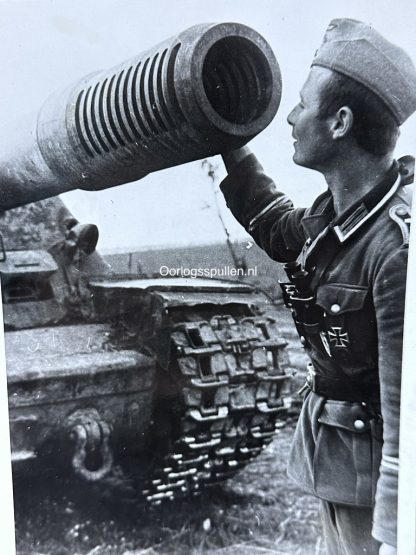 Original WWII German photo of a German soldier near a new Russian tank