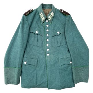 ChatGPT "Photograph showcasing a World War II Schutzpolizei Wachtmeister uniform, meticulously tailored with precise stitching and distinctive insignia, reflecting the authority and professionalism of the police attire during the wartime era. This uniform embodies the historical significance of the Schutzpolizei's role in maintaining order and security amidst the challenges of the Second World War, symbolizing their dedication and service to their communities."