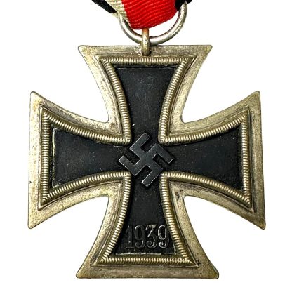 ChatGPT "Photograph showcasing the iconic German Iron Cross medal, characterized by its distinctive cross design with a central emblem, symbolizing bravery, honor, and valor in military service, evoking a sense of historical significance and recognition."