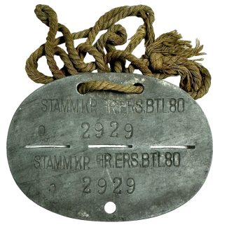 This is a German "Erkennungsmarke" also known as a dog tag which was worn by a soldier of the Grenadier-Ersatz-Bataillon 80 during World War II.