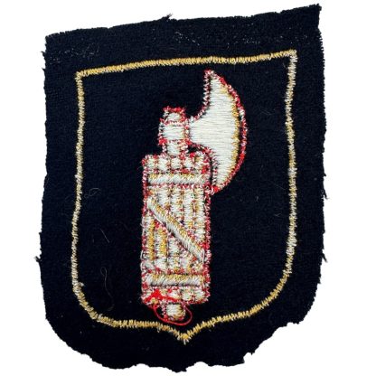 Cloth shield produced in the Dachau concentration camp for Italian volunteers in the Waffen-SS, featuring the fasces symbol and design elements specific to the unit.