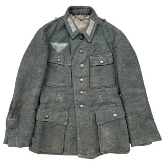 German Wehrmacht Model 1943 uniform jacket made in 1944 from Italian wool, featuring a field-grey color, four pockets, and an eagle insignia on the chest.