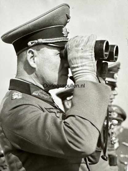 Field Marshal Erwin Rommel looking through his binoculars at the Normandy coast in 1944.