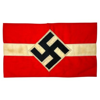 Original Hitler Youth armband from World War II, red with a white band and a black swastika in a diamond-shaped design, preserved in historical condition.