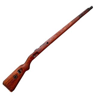 Image of a German wooden Mauser K98 rifle stock from World War II, featuring a deep brown, weathered finish and visible cutouts for attaching the rifle mechanism.