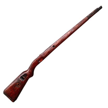 German WWII Mauser K98 wooden rifle stock, showcasing a rich reddish-brown finish, with visible wear and patina from age and use. The stock includes a cutout for the bolt handle and features slots for a sling, along with a detailed grain pattern typical of wartime production.