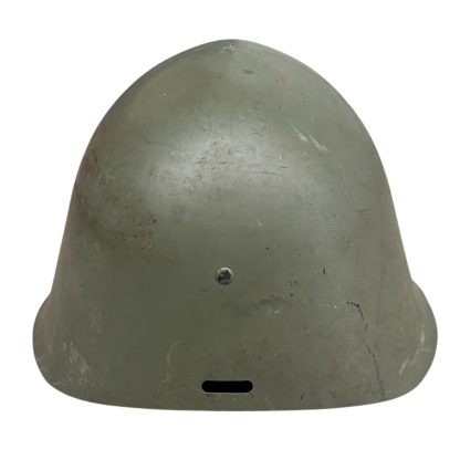 A WWII Danish M23/41 military helmet, featuring a rounded steel design with a green matte finish and a slightly flared brim. The helmet shows signs of wear, including scuffs and a small patch of exposed metal due to paint chipping. A single rivet is visible at the front for ventilation or securing the liner.