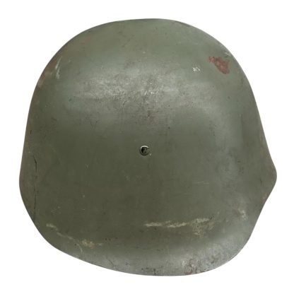 A WWII Danish M23/41 military helmet, featuring a rounded steel design with a green matte finish and a slightly flared brim. The helmet shows signs of wear, including scuffs and a small patch of exposed metal due to paint chipping. A single rivet is visible at the front for ventilation or securing the liner.