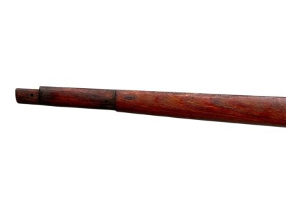 A vintage wooden rifle stock for a German WWII Mauser K98, showcasing a polished reddish-brown finish with visible wood grain texture. The design features a curved grip and cutouts for mounting hardware. The stock appears well-preserved with signs of age and use, such as minor scuffs and wear, adding to its historical authenticity.