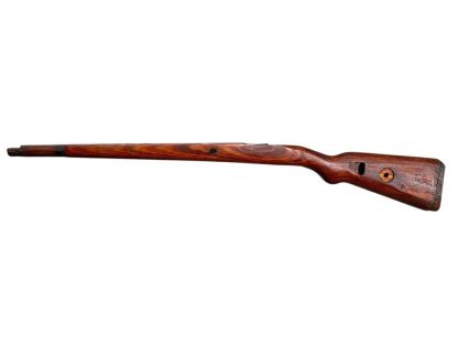 German WWII Mauser K98 wooden rifle stock, showcasing a rich reddish-brown finish, with visible wear and patina from age and use. The stock includes a cutout for the bolt handle and features slots for a sling, along with a detailed grain pattern typical of wartime production.