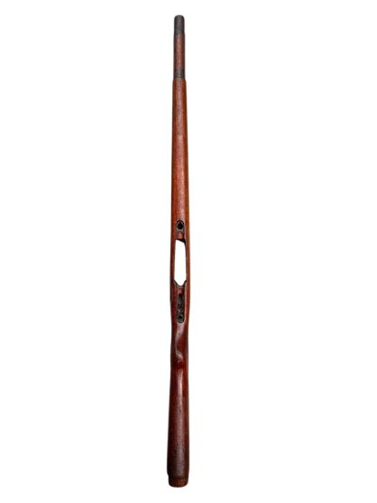 German WWII Mauser K98 wooden rifle stock, showcasing a rich reddish-brown finish, with visible wear and patina from age and use. The stock includes a cutout for the bolt handle and features slots for a sling, along with a detailed grain pattern typical of wartime production.