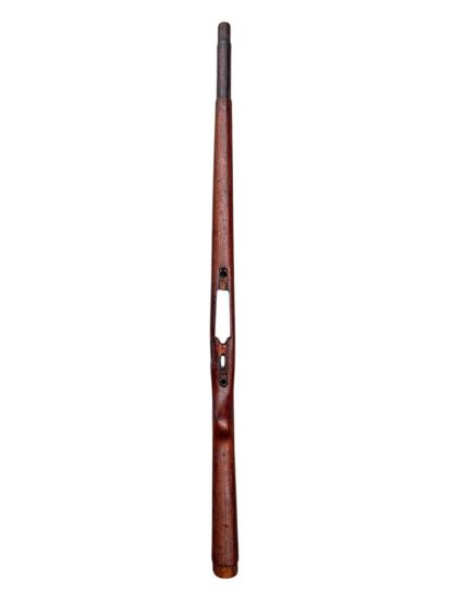 German WWII Mauser K98 wooden rifle stock, showcasing a rich reddish-brown wood finish with visible wear and aging, featuring the characteristic design for a bolt-action rifle. The stock includes a cutout for the bolt mechanism and a recess for the magazine well, highlighting its historical craftsmanship.