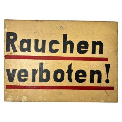 Metal German sign with the text 'Rauchen verboten!' from World War II, featuring a yellow background, black text with red underlining, and visible aging such as crackling and paint wear.