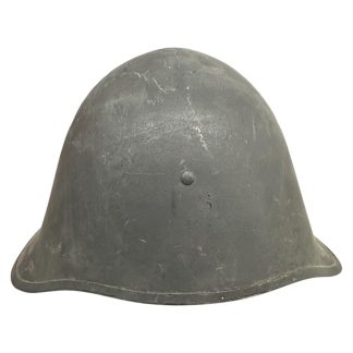 A WWII Danish M23/41 military helmet with a steel construction and a dark gray finish. The design features a rounded crown and a slightly flared brim for added protection. The surface shows light scratches and signs of wear, with a single central rivet visible at the front, indicating its attachment point for the internal liner. Militaria