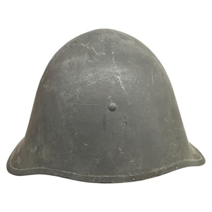 A WWII Danish M23/41 military helmet with a steel construction and a dark gray finish. The design features a rounded crown and a slightly flared brim for added protection. The surface shows light scratches and signs of wear, with a single central rivet visible at the front, indicating its attachment point for the internal liner. Militaria