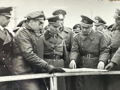 Foto fra 1943 af Erwin Rommel, omgivet af tyske officerer i Esbjerg, Danmark. Rommel og andre militærfolk studerer et kort, sandsynligvis som en del af strategisk militær planlægning under Anden Verdenskrig.