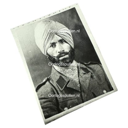 Black and white historical portrait of a Sikh soldier from the Freies Indien Legion, wearing a turban and a military uniform with epaulettes. His thick beard and mustache are well-groomed, and he has a serious expression. The uniform appears to be from the World War II era.