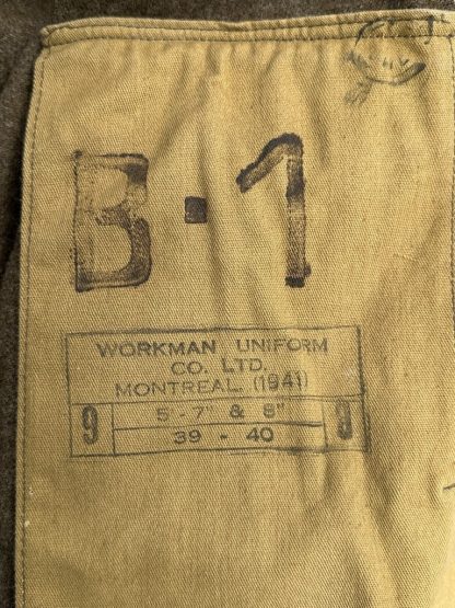 A vintage 1941 Canadian Battle Dress jacket in khaki wool, featuring two chest pockets with buttoned flaps, a fold-down collar, epaulets with buttons on the shoulders, and a belted waist. The jacket has a cropped fit, long sleeves with buttoned cuffs, and a partially visible beige lining. The fabric appears thick and durable, characteristic of World War II military uniforms.