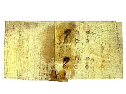 A worn and aged WWII US Airborne invasion armband featuring a faded American flag design with 48 stars, printed on a yellowed fabric background with visible cracks and creases.