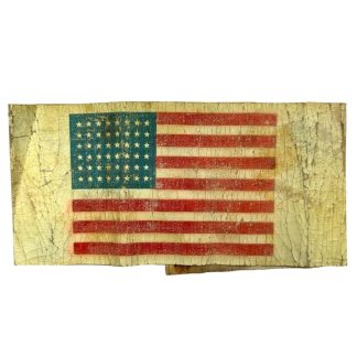 A worn and aged WWII US Airborne invasion armband featuring a faded American flag design with 48 stars, printed on a yellowed fabric background with visible cracks and creases.