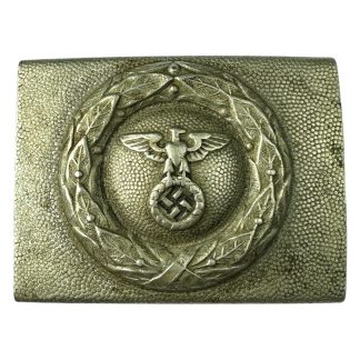 A silver-colored German DLV (Deutscher Luftsportverband) belt buckle featuring an embossed eagle with outstretched wings clutching a wreath enclosing a swastika, set against a pebbled-textured background with a decorative laurel wreath border."