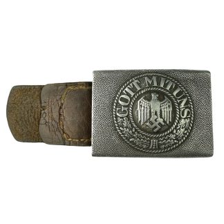 A German WWII Wehrmacht Heer belt buckle with a leather tab, manufactured by Overhoff & Cie. The rectangular aluminum buckle features a raised design with the German eagle clutching a swastika, encircled by a wreath and the inscription 'GOTT MIT UNS.' The leather tab shows signs of aging and wear.