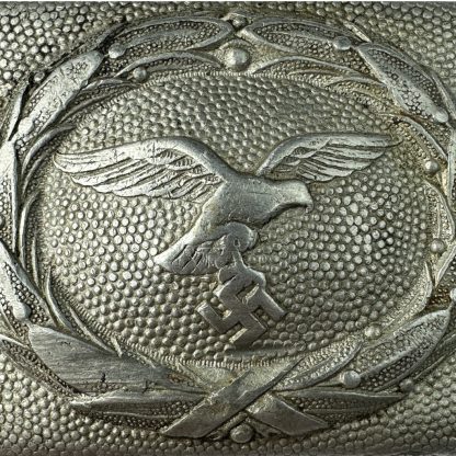 Original WWII German Luftwaffe belt buckle by Lind & Meyrer – aluminum construction featuring an eagle clutching a swastika within a detailed laurel wreath design.