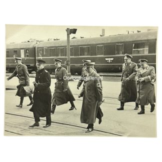 Historic WWII photo of Adolf Hitler arriving at a train station with high-ranking Nazi officers—ideal for Third Reich collectors, featuring detailed uniforms, swastika armband, and official railway carriage in background.