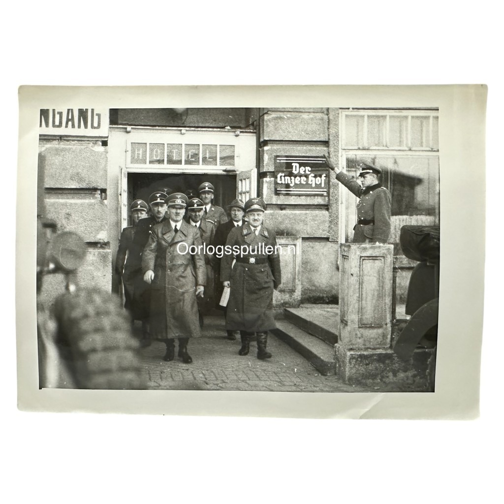 Rare WWII photo of Adolf Hitler exiting the ‘Der Linzer Hof’ hotel in Linz with SS officers—valuable for collectors of Third Reich memorabilia, showing original uniforms, architecture, and historical context.