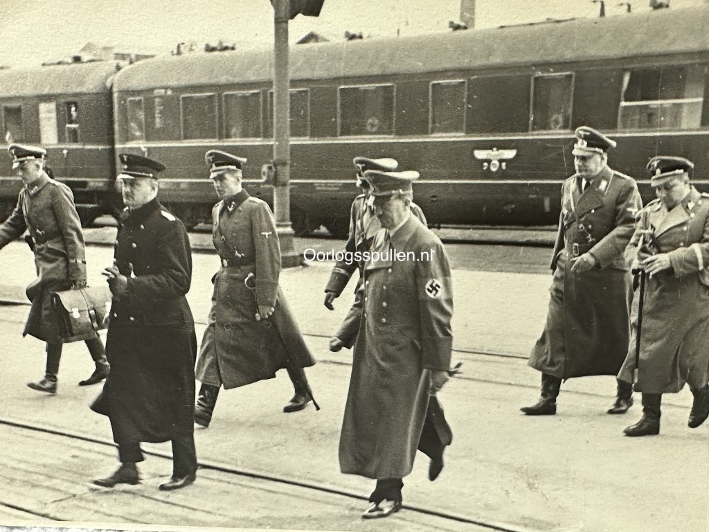 Historic WWII photo of Adolf Hitler arriving at a train station with high-ranking Nazi officers—ideal for Third Reich collectors, featuring detailed uniforms, swastika armband, and official railway carriage in background.