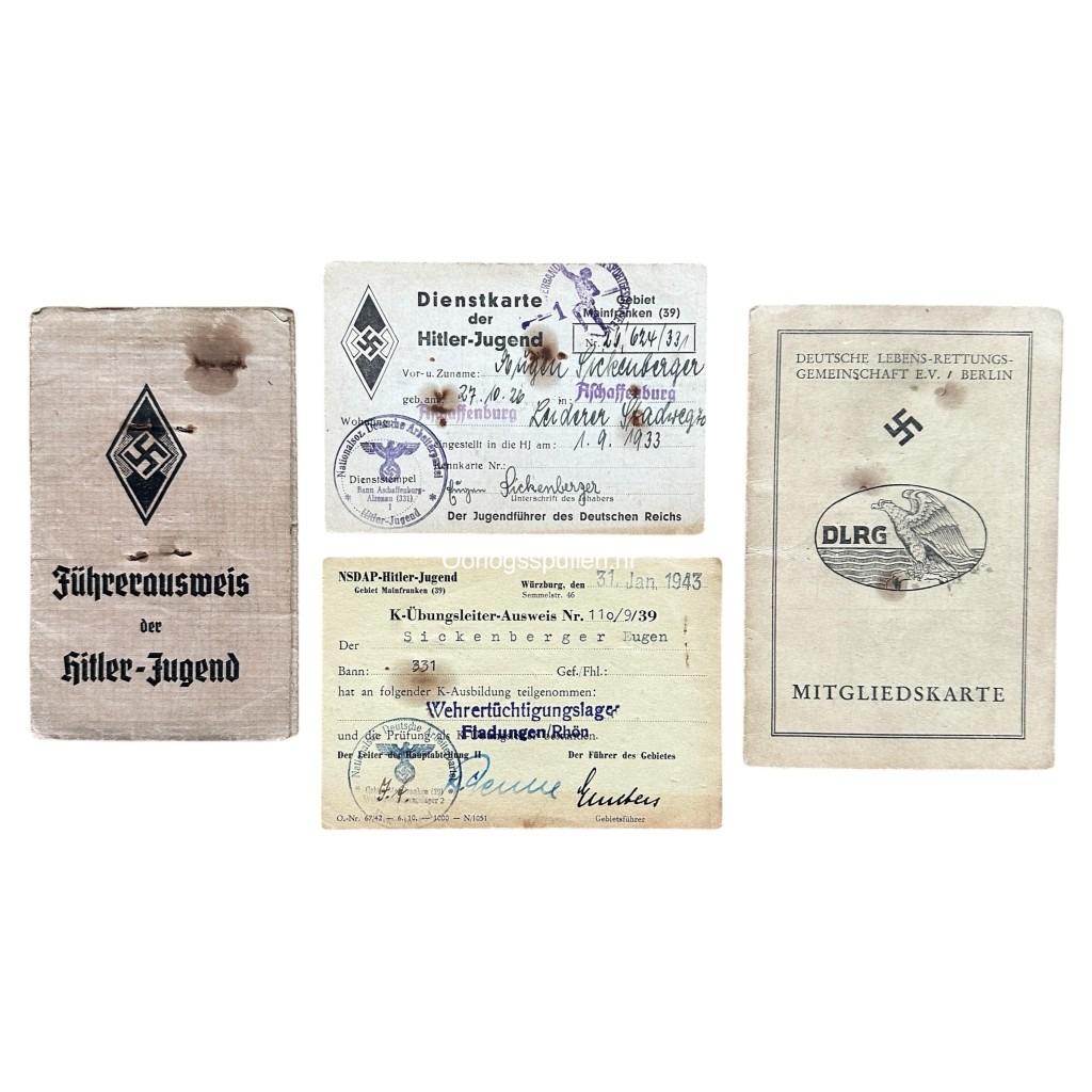 Original WWII German Hitler Youth (Hitlerjugend) identification document set from Aschaffenburg. The image shows four vintage items: a Führerausweis (leader ID booklet), a Dienstkarte (service card), a K-Übungsleiter-Ausweis (training instructor certificate dated 1943), and a DLRG (German Lifesaving Association) membership card. Each document includes Nazi insignia, stamps, and handwritten entries, reflecting the official documentation and affiliations of a Hitler Youth member during the Third Reich.