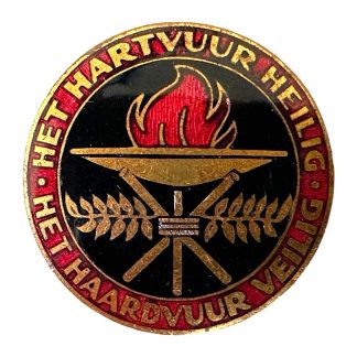 Badge of the Dutch National Socialist Women's Organization (NSVO), issued during World War II. Features a red and black enamel design with a burning flame in a brazier, flanked by laurel branches. Around the edge is the slogan: ‘Het Hartvuur Heilig – Het Haardvuur Veilig’ (The Heartfire Sacred – The Hearthfire Safe)