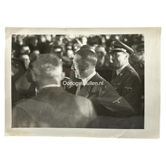 Original WWII photo of Adolf Hitler in uniform among Nazi officials—ideal for Third Reich collectors, featuring authentic insignia, historical crowd setting, and rare candid angle.