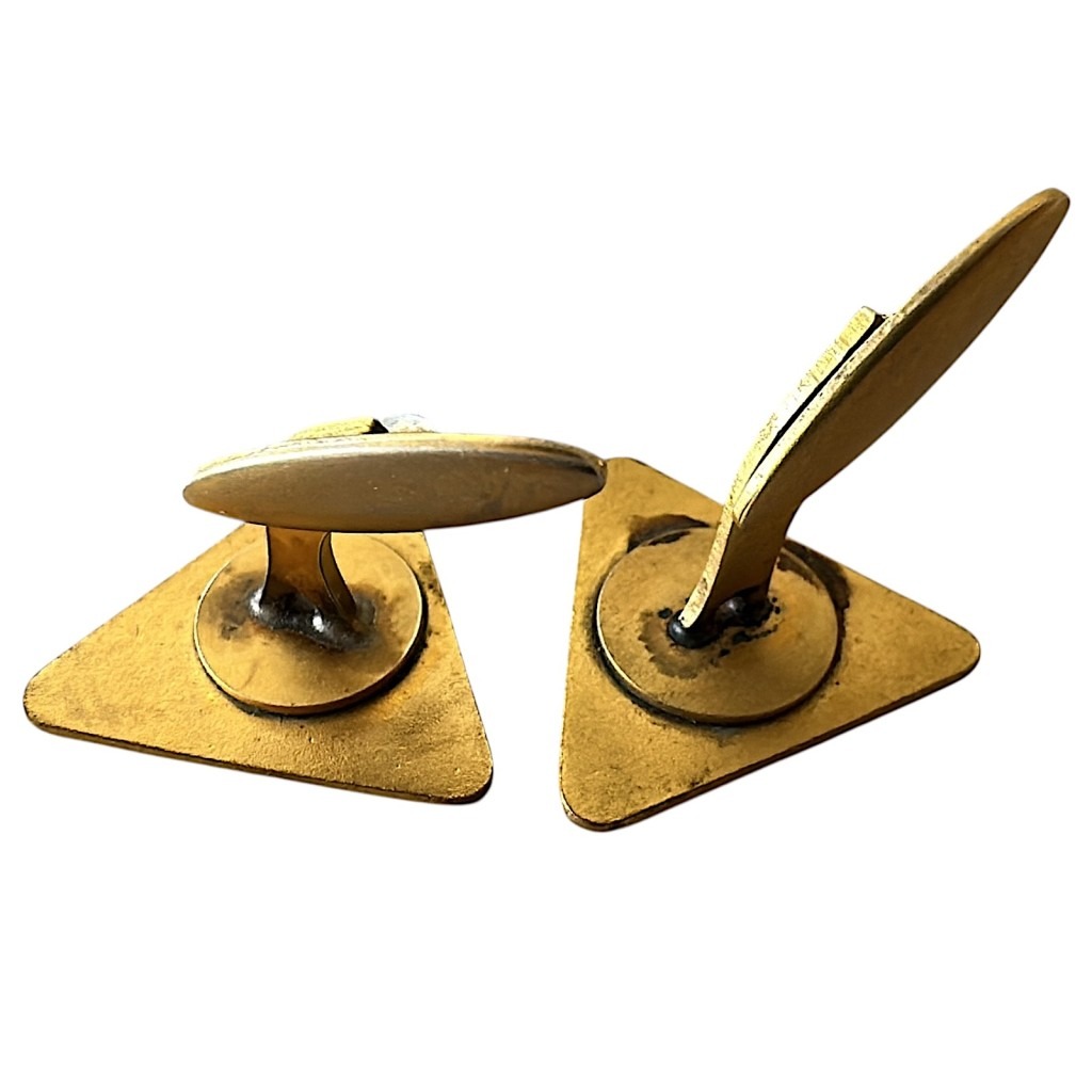 Original 1930s–1940s NSB cufflinks featuring the iconic triangular logo in black, red, and gold, with the Dutch lion and the letters N, S, and B – rare WWII-era historical collectible.