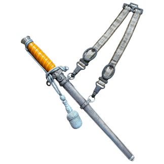 Original WWII German Heer officer’s dagger with orange grip, silvered scabbard, portepee knot, and suspension hanger – authentic Third Reich military collectible for edged weapon enthusiasts.