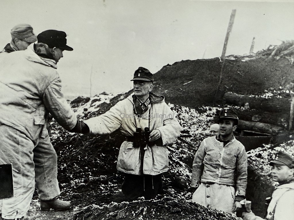 Original Foto Zweiter Weltkrieg zeigt Eichenlaubträger Oberst v.d. Goltz, Kommandeur eines Gebirgsjäger-Regiments, in Winterausrüstung mit Fernglas im Gespräch mit seinen Soldaten an der Front. Historische Aufnahme vom 6. Februar 1944 mit SIPHO Presse-Stempel, seltenes Sammlerstück für Gebirgsjäger, Wehrmacht und Ritterkreuz-Träger Memorabilia.