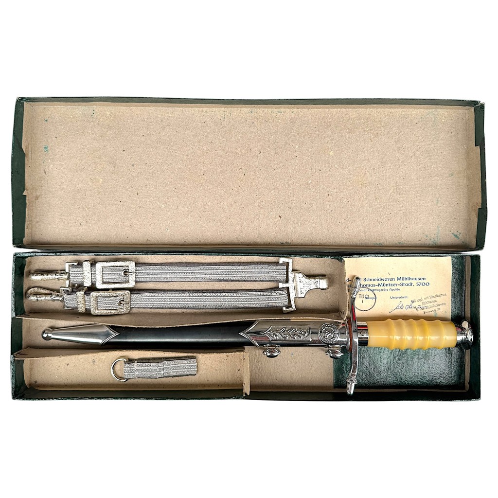 Original NVA DDR dagger for Land and Air Forces in box with suspension straps, belt loop and certificate – East German officer dagger complete set for collectors.