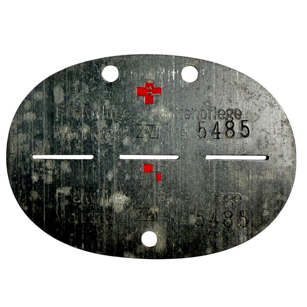 Original WWII German Red Cross dog tag Erkennungsmarke Freiwillige Krankenpflege Wehrkreis XVII No. 5485 with red enamel cross – rare DRK medical ID disc.