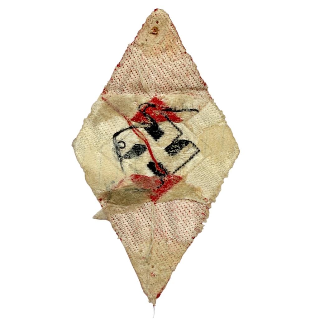 Backside of original WWII Hitler Youth (HJ) / BDM sleeve diamond insignia – authentic stitching and attachment traces visible.
