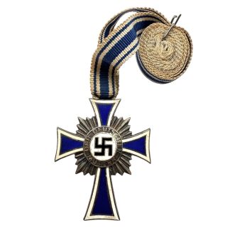 Original WWII German Mother’s Cross in Silver (Silbernes Mutterkreuz) with blue-and-white enamel cross, silver sunburst backing, and intact long neck ribbon. Authentic Third Reich-era medal sought by German militaria collectors.
