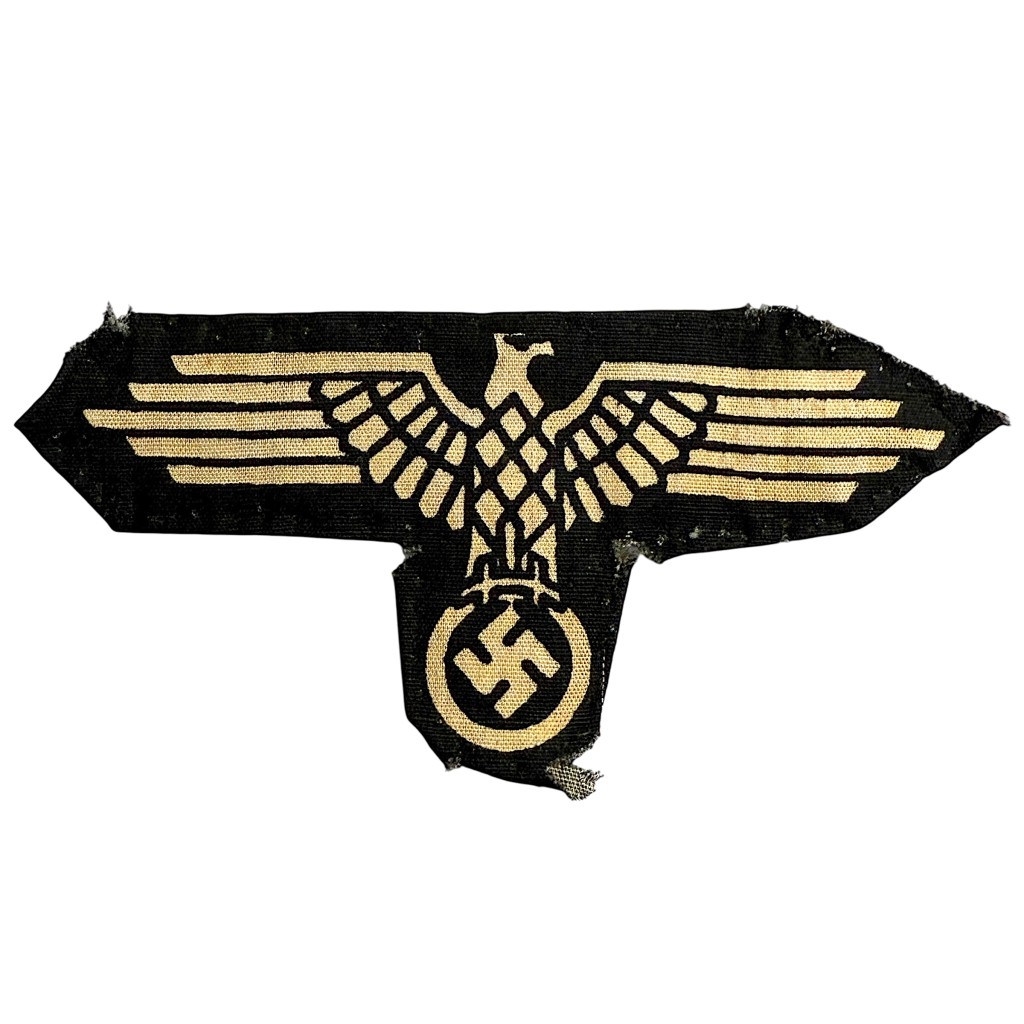 Original late-war Waffen-SS sleeve eagle, printed on black cotton fabric with eagle and swastika design. Authentic WWII German cloth insignia in worn, field-used condition — rare late-war variant sought after by Waffen-SS and military uniform collectors.