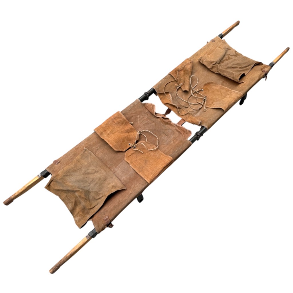 Original 1939 German GEFRAG military stretcher from World War II with “GEFRAG 1939 D.R.P.” stamp, original green paint, canvas body, wooden poles, and metal hinges, authentic Wehrmacht Sanitätsdienst field medical equipment, rare WWII militaria collectible.