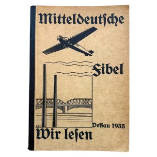 Original 1935 German school book “Mitteldeutsche Fibel – Wir lesen” published in Dessau by Georg Westermann Verlag. Early Third Reich children’s reading primer with aviation artwork and Gothic Fraktur lettering, used in Nazi-era schools.