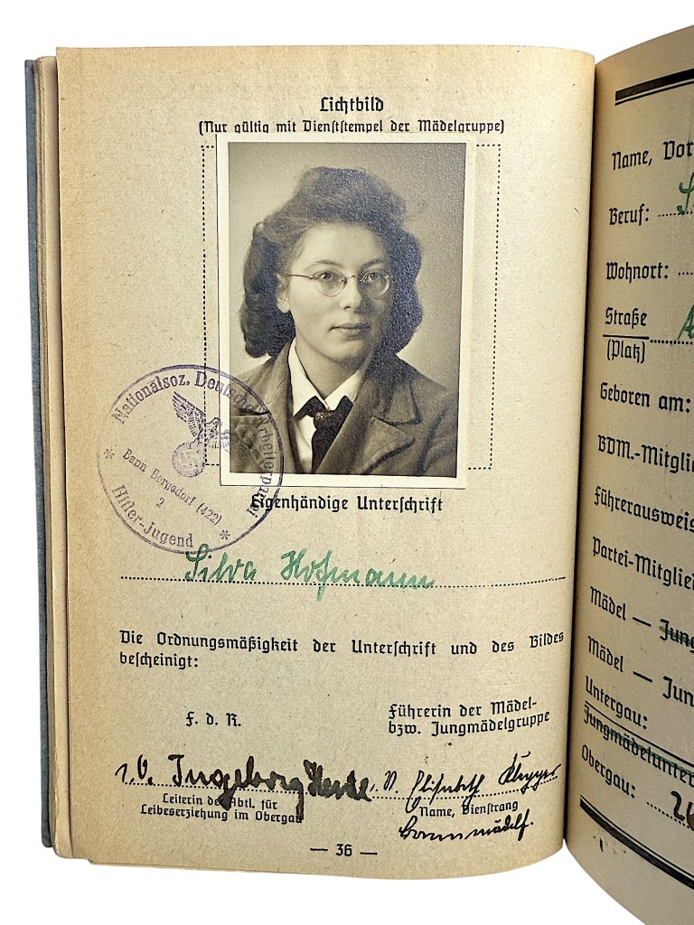 Original WWII German BDM Leistungsbuch showing portrait photo of member Silva Hofmann with official Nazi stamps and handwritten details. Rare Bund Deutscher Mädel document from Hamburg-Bergedorf, ideal for WWII collectors.