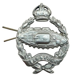 Original WWII British Royal Tank Regiment cap badge with Fear Naught motto, showing detailed tank emblem, laurel wreath, and King’s Crown.