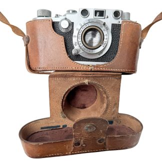 Original WWII German Kriegsmarine Leica camera by Ernst Leitz Wetzlar with Hektor 5cm f/2.5 lens, rare military-issued model with Kriegsmarine eagle marking, complete with leather case – unique collectible for Kriegsmarine and World War II militaria enthusiasts.
