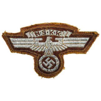 Embroidered German NSKK sleeve insignia from World War II with eagle and cogwheel on a brown background, including the original RZM label.
