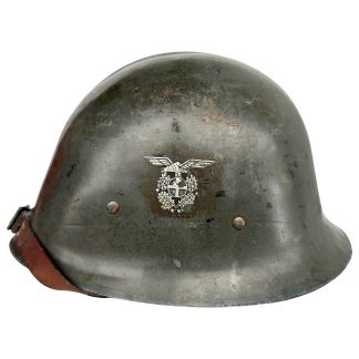 Original World War II Norwegian M31 Nasjonal Samling helmet featuring the NS eagle-and-wreath decal on the front, complete with wartime paint and leather chinstrap. Rare Norwegian collaboration-era military helmet prized by collectors of Nasjonal Samling, Quisling government artifacts, and WWII occupation-era militaria.