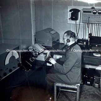 Original WWII German photo positive of the Wolfsschanze Funkstation showing SS communication officer operating telex and radio equipment, rare unpublished Third Reich bunker and signals photograph for WWII photo collectors.